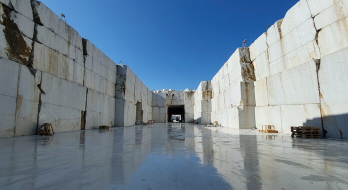Open pit quarry marble mine with walls and blue sky